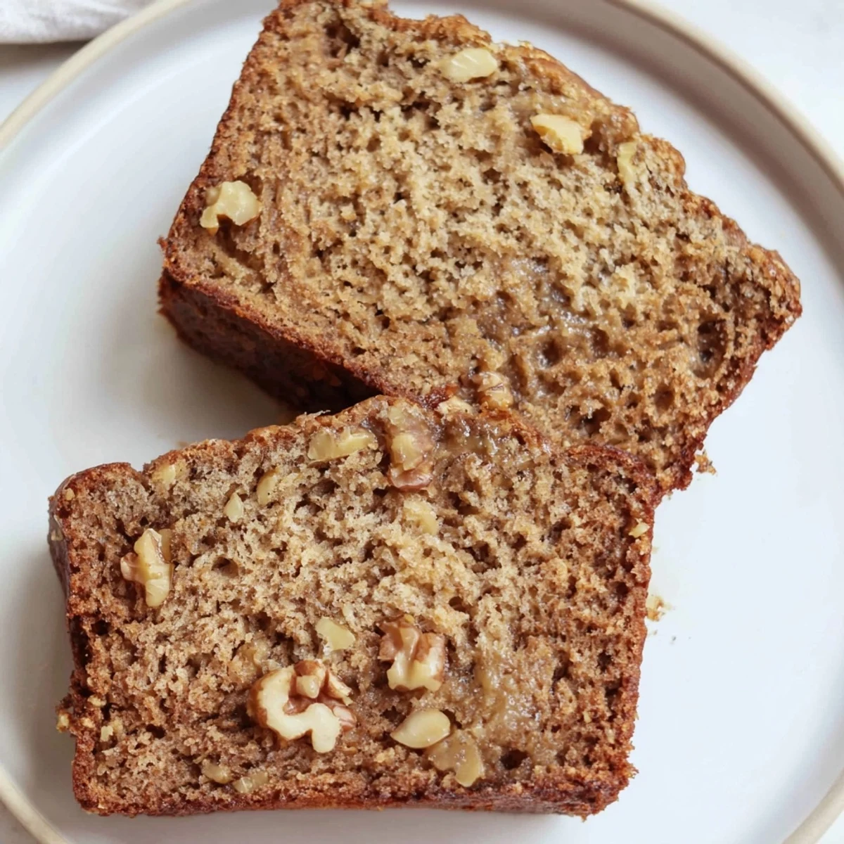 This moist Simple Banana Bread Loaf, with visible banana pieces, looks perfect for breakfast or dessert.