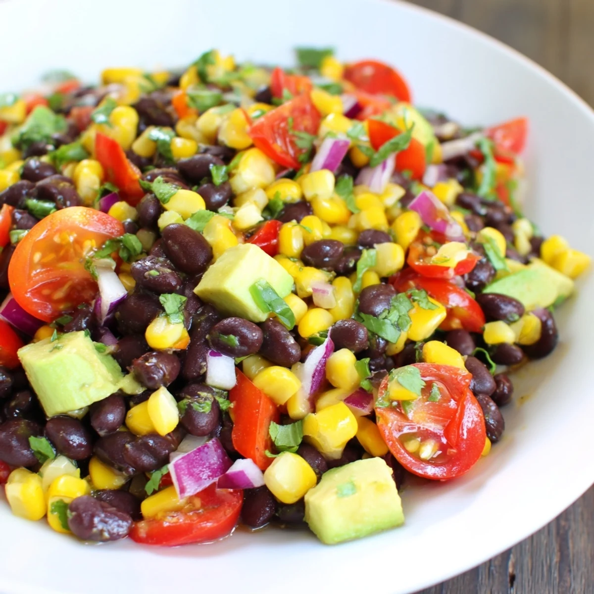 A colorful bowl of Southwestern Black Bean and Corn Salad, ready to be enjoyed with crispy tortilla chips.