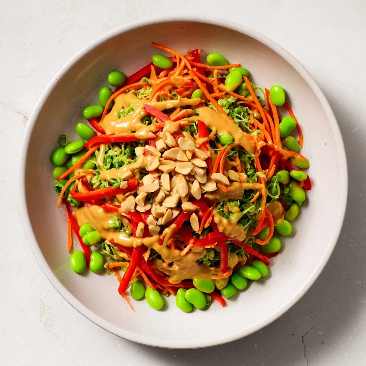 A refreshing bowl of Crunchy Cabbage and Edamame Salad, scattered with crunchy seeds and toasted almonds.