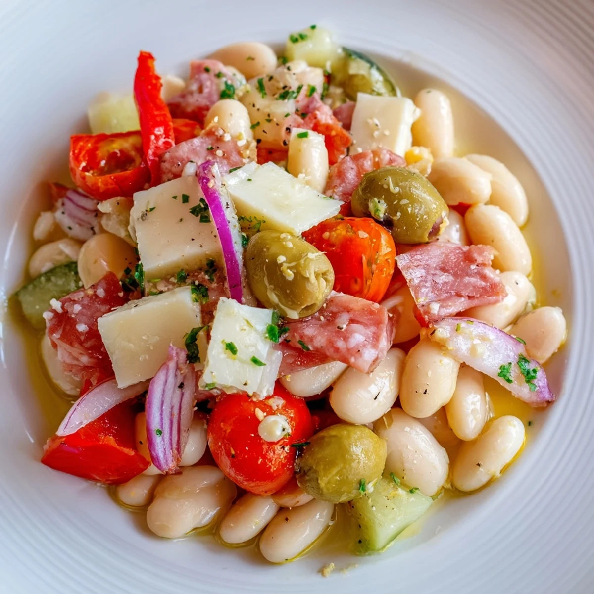 Italian antipasto bean salad with fresh parsley, salami, and provolone, ready to be enjoyed.