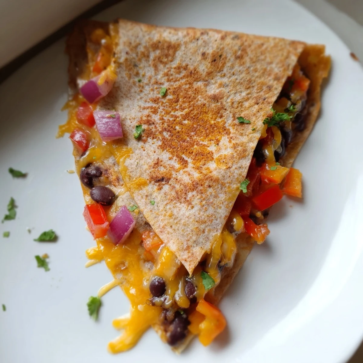 A sizzling pan displaying a hearty, flavorful Black Bean Quesadilla ready to be served.
