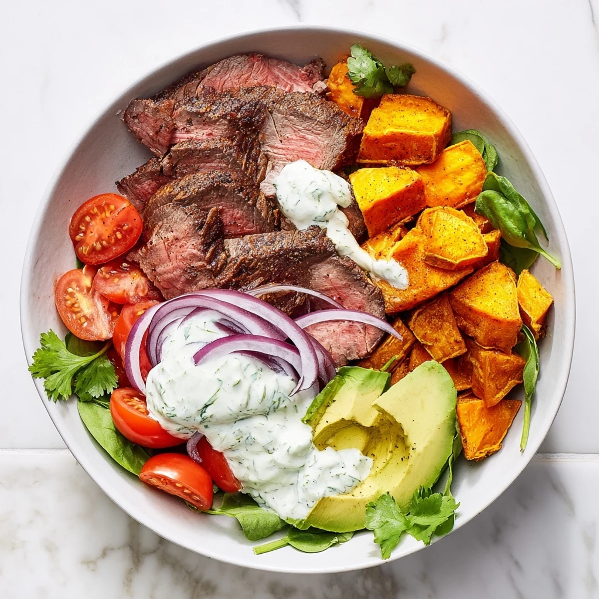 Delicious, gluten-free Beef Avocado Sweet Potato Bowl served with fresh avocado and cherry tomatoes for lunch.
