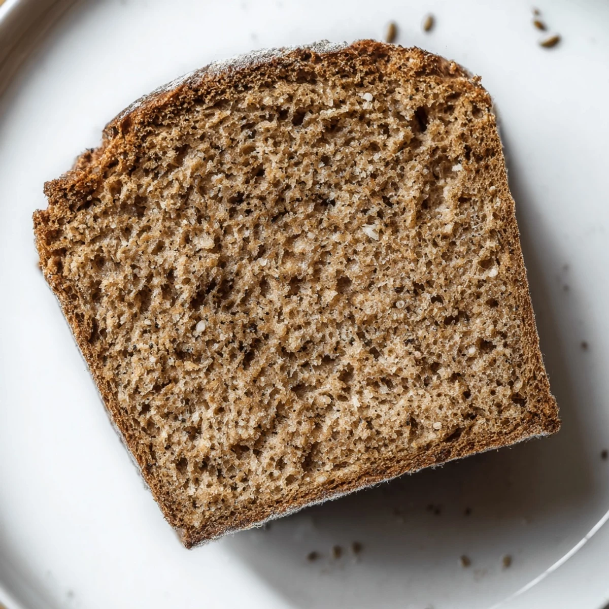 A rustic image of warm, homemade Latvian Rupjmaize bread, ready to slice for a delicious meal.