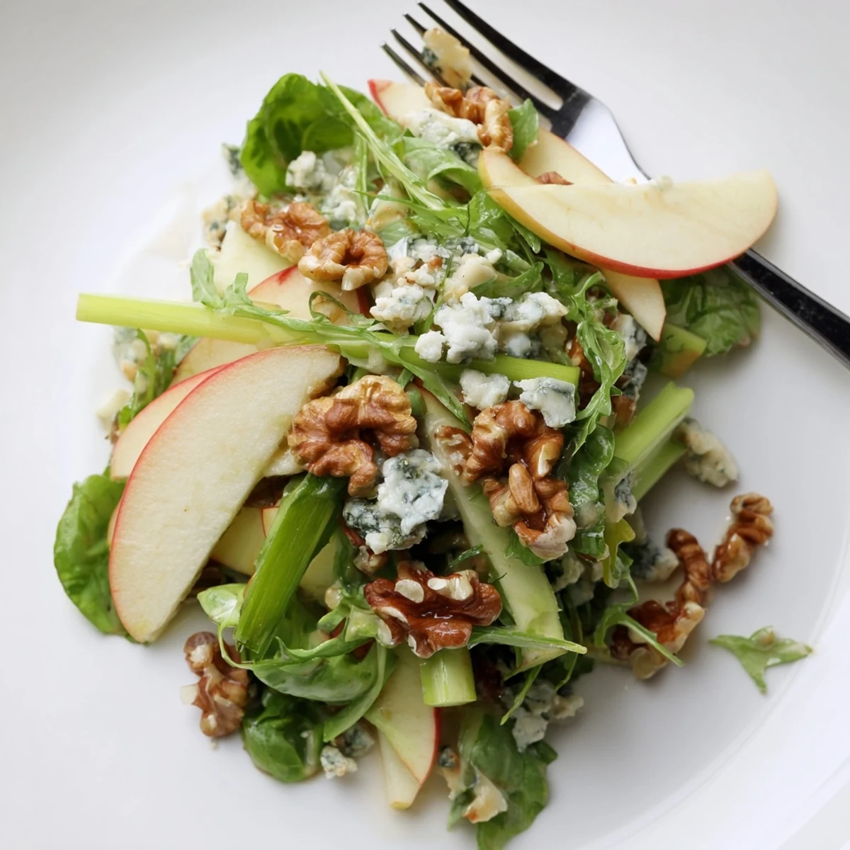 Colorful Apple and Walnut Salad served on a platter, garnished with fresh arugula and walnuts for a crunchy winter appetizer.