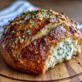 Perfect Parmesan Garlic Artisan Bread reveals a soft, cheesy crumb studded with minced garlic.