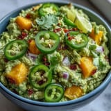 Creamy guacamole with mango and jalapeño, a vibrant appetizer perfect for Cinco de Mayo celebrations.