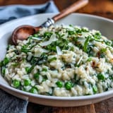 Bright green peas and aromatic mint add freshness to this comforting, slow-simmered Arborio rice dish with Parmesan.  