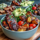 Colorful BBQ chicken meal prep bowls with sweet potato, beans, and corn.