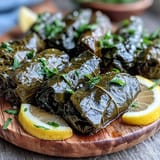 Perfectly rolled Kurdish Dolma, glistening with olive oil, a delightful appetizer.