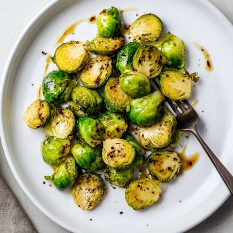 Caramelized roasted Brussels sprouts glazed with balsamic reduction, served warm as a golden, savory-sweet holiday side dish.