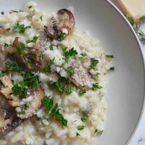 Stove-Top Creamy Risotto: A steaming bowl of creamy risotto with visible Parmesan, ready to eat.