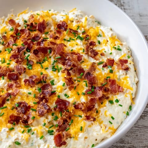 Golden-brown Cheesy Bacon Ranch Dip: a comforting appetizer with melty cheese and savory bacon bits.
