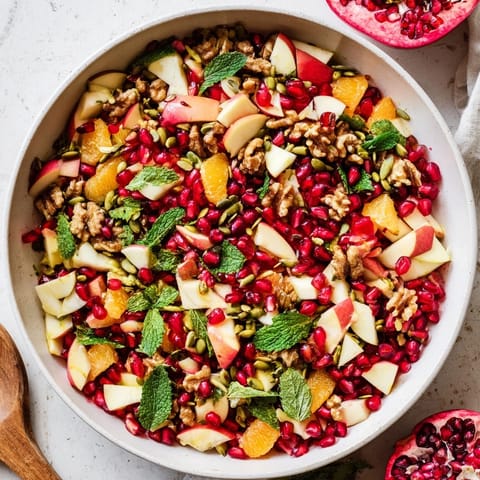 This vibrant Pomegranate and Walnut Salad features juicy orange segments and crunchy seeds, perfect for a healthy, refreshing side dish.  