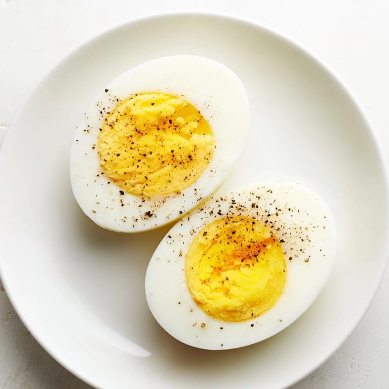 Plated perfect hard-boiled eggs, beautifully arranged and ready for a savory breakfast or snack.