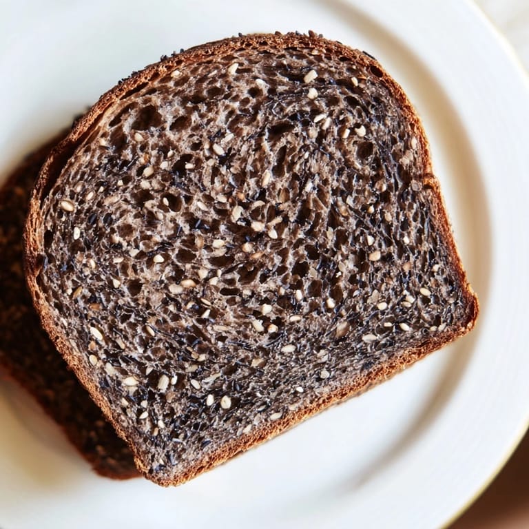 This beautiful photo shows a deeply flavorful Estonian Leib Sourdough, baked to perfection with caraway seeds.