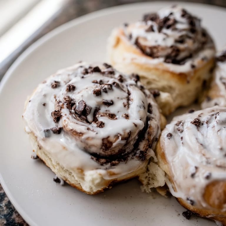 A close-up of warm Nutella Chocolate Chip Rolls revealing melted chocolate chips and a gooey, swirled Nutella center.