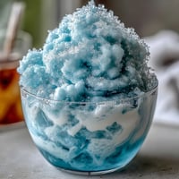 A frosty, fluffy TikTok Cloud Slushie made with lemon-lime soda, ice, and sweetened condensed milk, served in clear glasses.