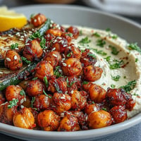 Crispy Chickpea Bowls with hummus and grilled vegetables, served in a colorful, healthy Mediterranean meal bowl.  