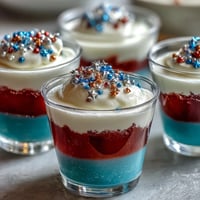 Vibrant alcohol-free 4th of July Firecracker Jello Shots layered with red, white, and blue.